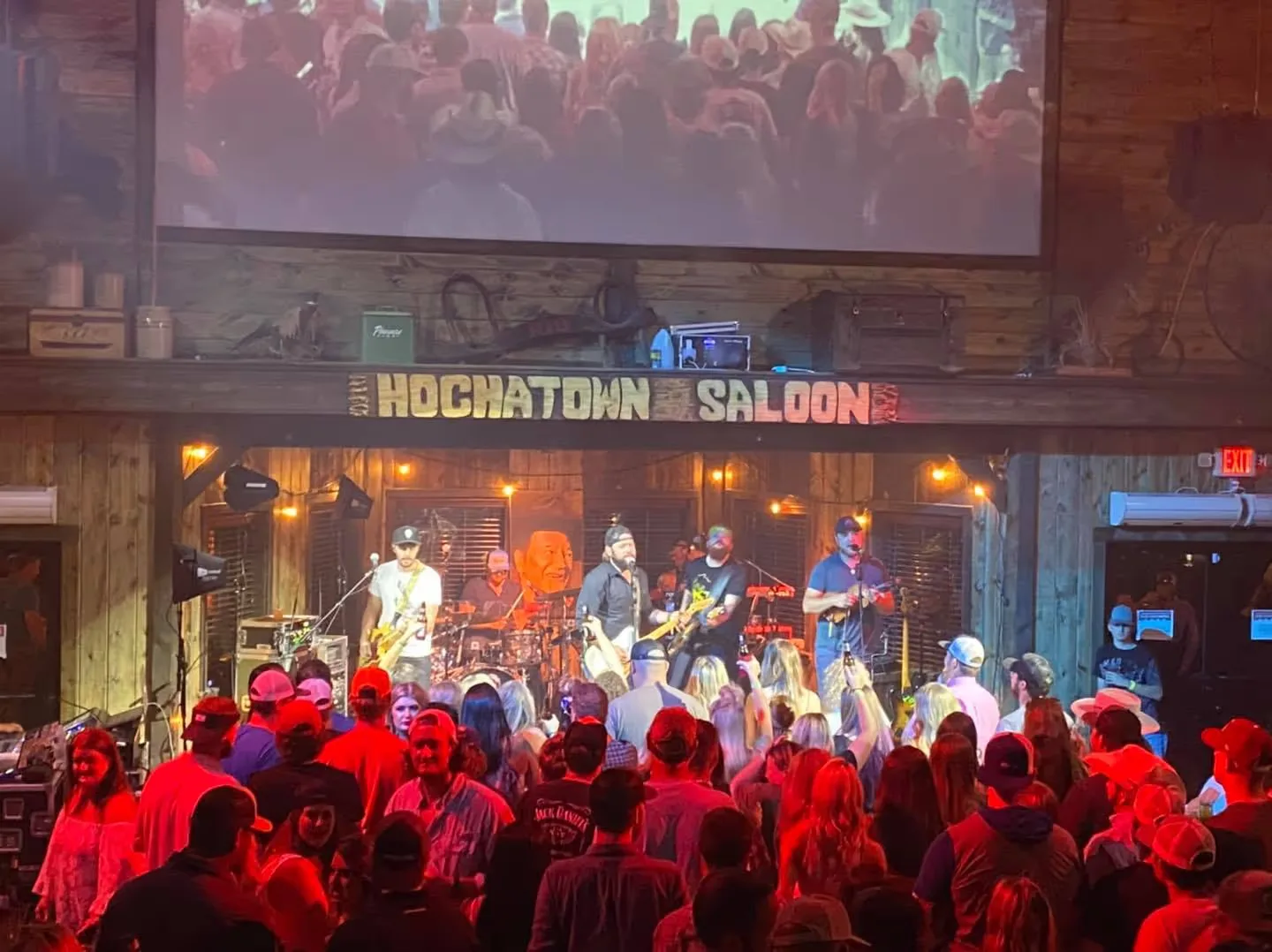 Band playing to a packed room under the Hochatown Saloon sign