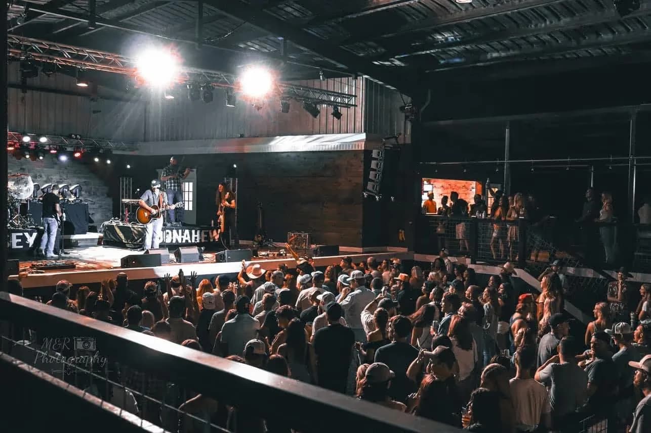 Crowd filling the venue floor in front of the stage